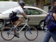 Vancouver police Officer Ed Letarte patrols Sixth Street in downtown Vancouver in July 2002. The police department is re-implementing the bike officer unit for the first time in nearly a decade.