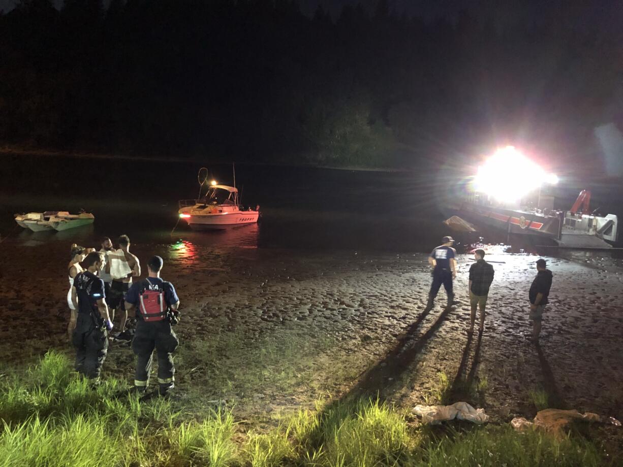 Police and fire crews respond after two boats collided beneath the Camas Slough bridge Sunday evening. One boater, a woman in her 20s, was killed, according to the Camas-Washougal Fire Department, and two others were injured.