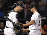 Chicago White Sox relief pitcher Ian Hamilton, right, celebrates with catcher Kevan Smith after the White Sox defeated the Boston Red Sox 6-1 in a baseball game, early Saturday, Sept. 1, 2018, in Chicago. Hamilton, a Skyview High grad, was making his major league debut. (AP Photo/Nam Y.