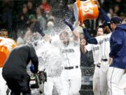 Seattle Mariners' Chris Herrmann gets a Gatorade shower after hitting a walk-off two-run home run against the Oakland Athletics during the eleventh inning of a baseball game Tuesday, Sept. 25, 2018, in Seattle. Seattle won 10-8.