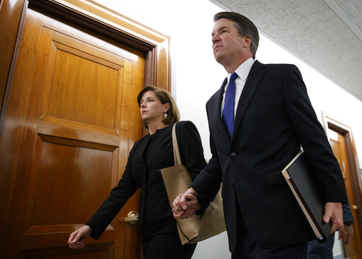 Brett Kavanaugh, President Donald Trump's Supreme Court nominee, and his wife Ashley Kavanaugh, hold hands as they arrive for a Senate Judiciary Committee hearing on Capitol Hill in Washington, Thursday, Sept. 27, 2018.