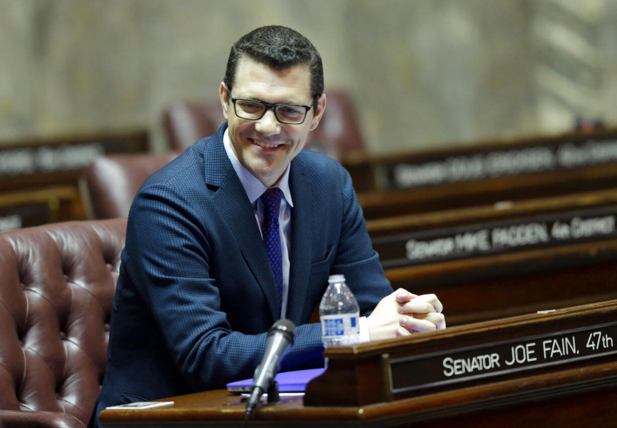 In this Jan. 27, 2017 photo, Senate Republican floor leader Joe Fain, R-Auburn, sits at his desk on the Senate floor in Olympia, Wash. A woman has accused Fain of raping her 11 years ago, saying she was inspired to speak out following the televised allegations against Supreme Court nominee Brett Kavanaugh. In a tweet Thursday, Sept. 27, 2018,  Candace Faber said Fain sexually assaulted her in 2007. Fain says he "absolutely" denies the claim and called for an investigation. (AP Photo/Ted S.