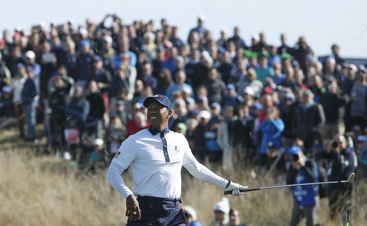 Tiger Woods of the US takes his hand off his club after playing on the 10th during a fourball match on the second day of the 42nd Ryder Cup at Le Golf National in Saint-Quentin-en-Yvelines, outside Paris, France, Saturday, Sept. 29, 2018.