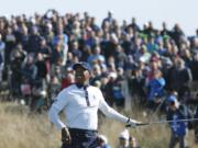 Tiger Woods of the US takes his hand off his club after playing on the 10th during a fourball match on the second day of the 42nd Ryder Cup at Le Golf National in Saint-Quentin-en-Yvelines, outside Paris, France, Saturday, Sept. 29, 2018.