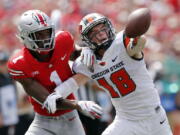 Ohio State defensive back Jeffrey Okudah, left, knocks the ball away from Oregon State wide receiver Timmy Hernandez during the first half of an NCAA college football game Saturday, Sept. 1, 2018, in Columbus, Ohio.