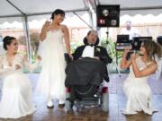 Akhil Jhaveri, center, watches as his three daughters, Jordan Jhaveri, left, Ashley Jhaveri and Corinne Jhaveri dance around their father July 30 during an honorary wedding at Vintage Gardens in Ridgefield. He asked for the wedding as a final wish. He died Saturday at age 52.