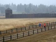 Rain soaks runners navigating Fort Vancouver during the inaugural Apple Tree Marathon in Vancouver on Sunday, September 16, 2018.