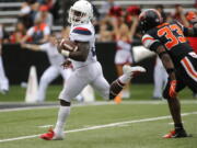 Arizona running back J.J. Taylor looks back at Oregon State’s Jalen Moore as he heads to the end zone on a 62 run in the fourth quarter of an NCAA college football game in Corvallis, Ore., Saturday, Sept 22, 2018. Arizona won 35-14. (AP Photo/Timothy J.