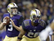 Washington quarterback Jake Browning looks to pass behind running back Salvon Ahmed during the second half of an NCAA college football game against BYU, Saturday, Sept. 29, 2018, in Seattle. (AP Photo/Ted S.