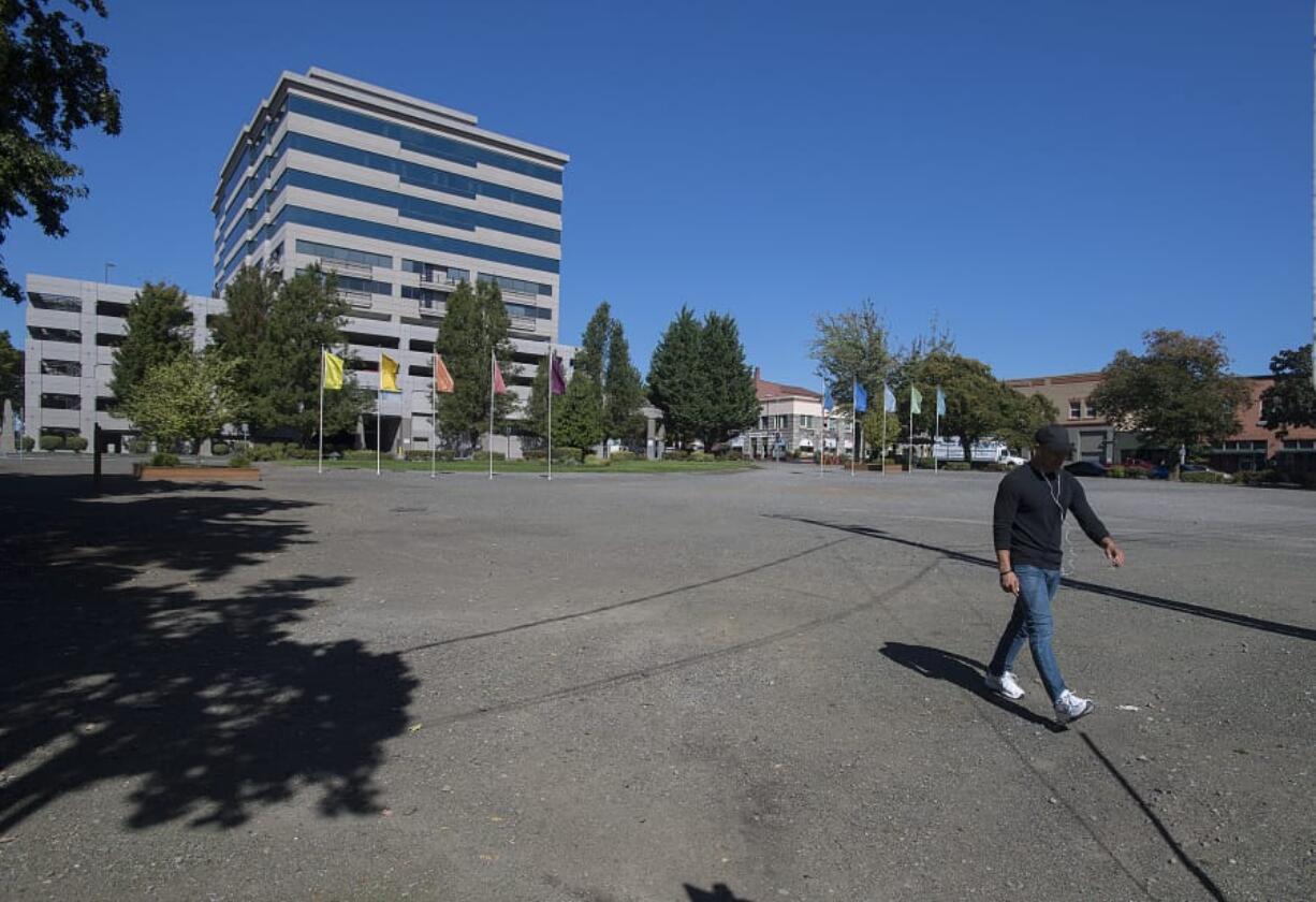 Anthony Ringering of Vancouver strolls across Block 10 on Monday in downtown Vancouver. Gramor Development has presented Vancouver city officials with a timeline for completion of the long-awaited project.