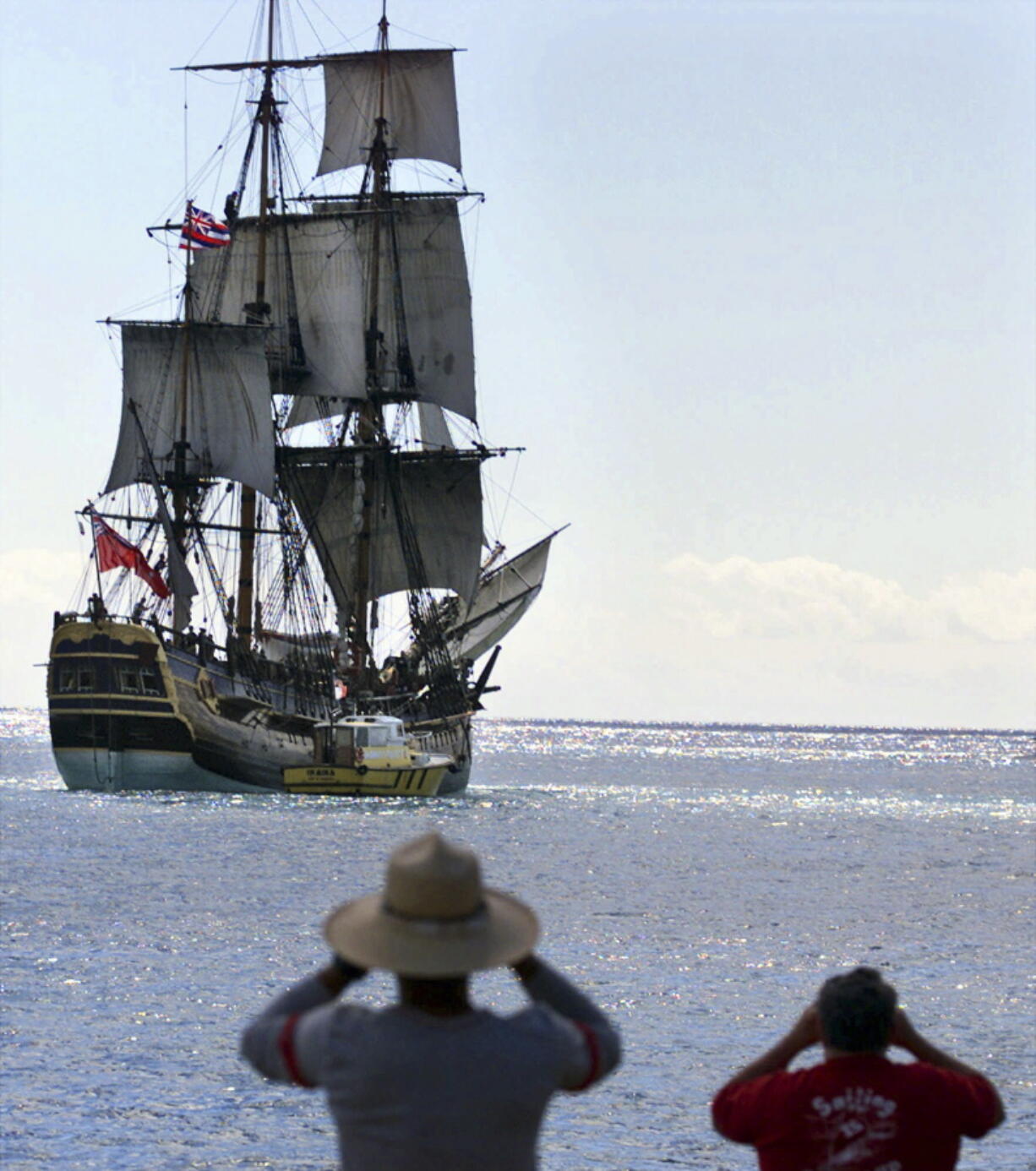 FILE - In this Nov. 15, 1999, file photo, people watch as a replica of the HMB Endeavour leaves Honolulu, as it embarked on a four-year, around-the-world cruise. The original vessel was commanded by Capt. James Cook in the 1700s when he became the first European to chart Australia’s East Coast. Researchers said in September 2018 they’ve found a site where they think the ship that Cook used sank and may be located, and are planning an excavation off the coast of Rhode Island.