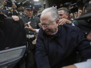 Fernando Karadima is escorted from a court, after testifying in a case that three of his victims brought against the country’s Catholic Church in Santiago, Chile. Pope Francis has on Friday, Sept. 29, 2018, defrocked Karadima, a priest at the center of the global sex abuse scandal rocking his papacy, invoking his “supreme” authority to stiffen a sentence originally handed down by a Vatican court in 2011.