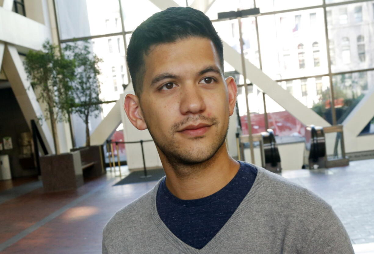 In this Friday, Sept. 7, 2018 photo, Chris Damian poses in Minneapolis. Damian believes having more nuanced conversations about hard topics like sex abuse by priests and allegations of cover-ups by church leaders can bring about change. Damian, 27, has organized a group of Catholic young adults to respond to the church crisis.