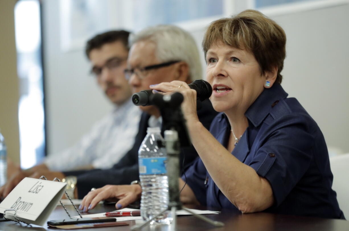 FILE - In this July 17, 2018, photo, Lisa Brown, the Democratic opponent to Rep. Cathy McMorris Rodgers, R-Wash., speaks during a candidates forum in Colfax, Wash. Some Democratic candidates are determined not to let Republican members of Congress distance themselves from the president’s trade policies. Their efforts play into voter concerns that Congress should be more of a check on Trump. Republicans hope that a strong economy carries them to victory. (AP Photo/Ted S.