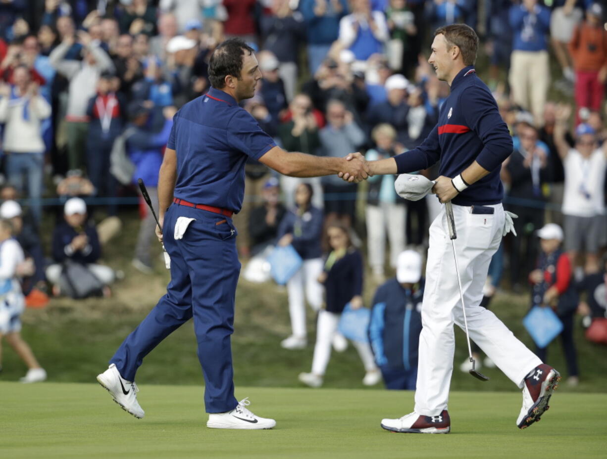 Europe’s Francesco Molinari, left, shakes hands with Jordan Spieth of the US after winning a foursome match with his partner Tommy Fleetwood on the opening day of the 42nd Ryder Cup at Le Golf National in Saint-Quentin-en-Yvelines, outside Paris, France, Friday, Sept. 28, 2018. Molinari and Fleetwood beat Justin Thomas of the US and Jordan Spieth 5 and 4.