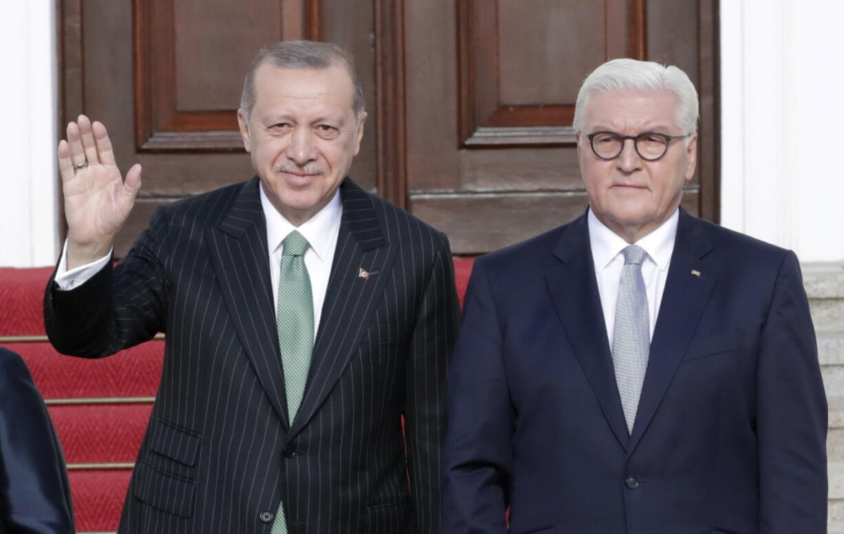 Turkish President Recep Tayyip Erdogan, left, waves as he is welcomed by German President Frank-Walter Steinmeier at the presidential palace in Berlin, Germany, on Friday. Erdogan is on a three-day official state visit to Germany.