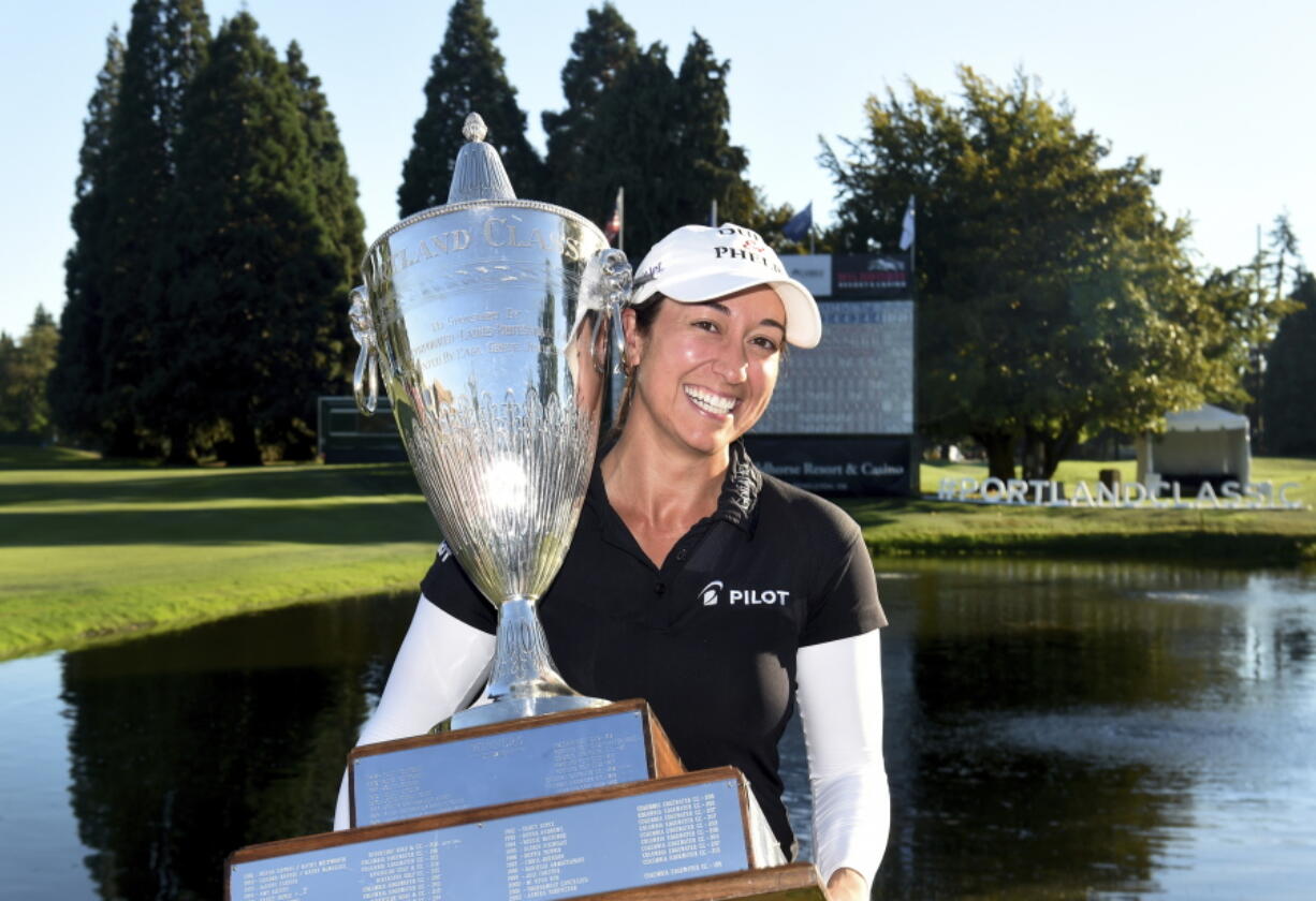 Marina Alex holds the trophy after winning the LPGA Cambia Portland Classic golf tournament in Portland, Ore., Sunday, Sept. 2, 2018.