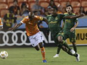 Houston Dynamo defender DaMarcus Beasley (7) and Portland Timbers defender Alvas Powell (2) battle for possession of the ball during the first half of the MLS soccer game at BBVA Compass Stadium on Saturday, Sept. 15, 2018, in Houston.