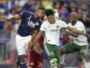 New England Revolution defender Michael Mancienne, left and New England Revolution goalkeeper Matt Turner (30) defend a corner kick as Portland Timbers defender Julio Cascante, second left, and midfielder Dairon Asprilla (27) attack during the second half of an MLS soccer match in Foxborough, Mass., Saturday, Sept. 1, 2018.