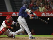 Seattle Mariners’ Robinson Cano connects for a three-run double during the eighth inning of a baseball game against the Los Angeles Angels, Saturday, Sept. 15, 2018, in Anaheim, Calif. (AP Photo/Jae C.