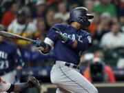 Seattle Mariners’ Robinson Cano, right, hits a RBI single as Houston Astros catcher Martin Maldonado reaches for the pitch during the first inning of a baseball game Wednesday, Sept. 19, 2018, in Houston.(AP Photo/David J.