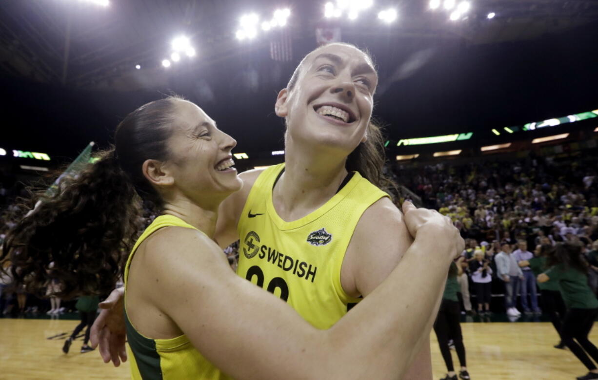 Seattle Storm's Breanna Stewart, right, is embraced by Sue Bird after the Storm defeated the Phoenix Mercury 94-84 during Game 5 of a WNBA basketball playoff semifinal, Tuesday, Sept. 4, 2018, in Seattle. The Storm advanced to the WNBA finals.