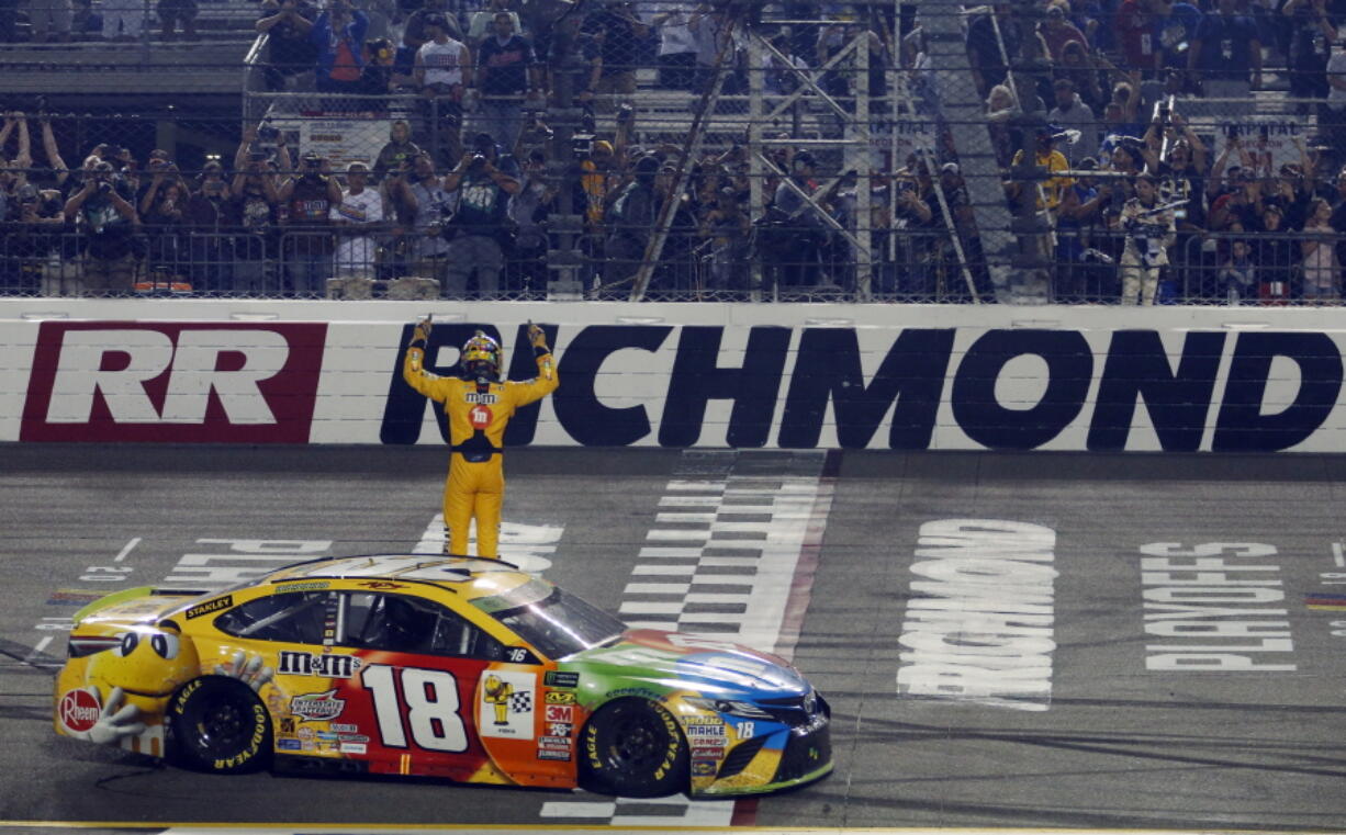 Kyle Busch (18) celebrates winning the NASCAR Cup Series auto race at Richmond Raceway in Richmond, Va., Saturday, Sept. 22, 2018.