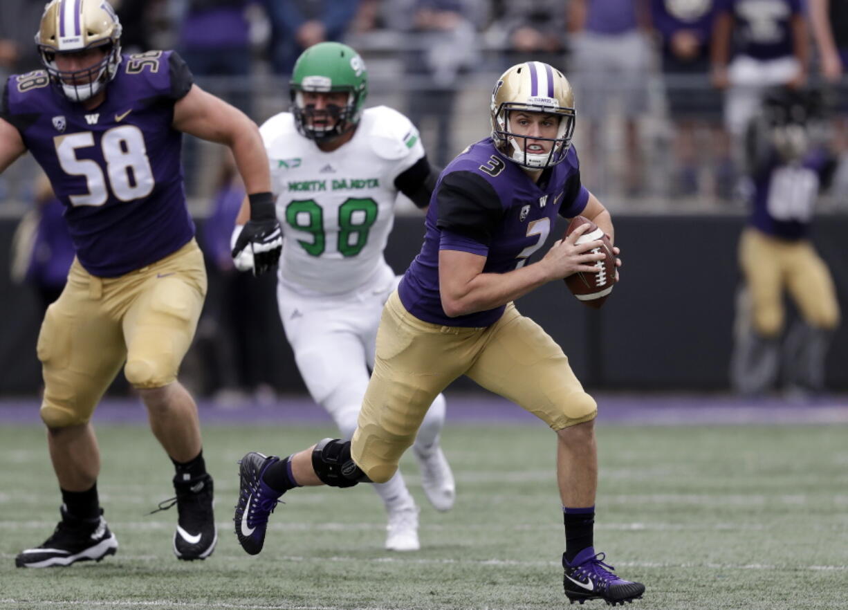 Washington quarterback Jake Browning (3) scrambles against North Dakota in the first half of an NCAA college football game Saturday, Sept. 8, 2018, in Seattle.