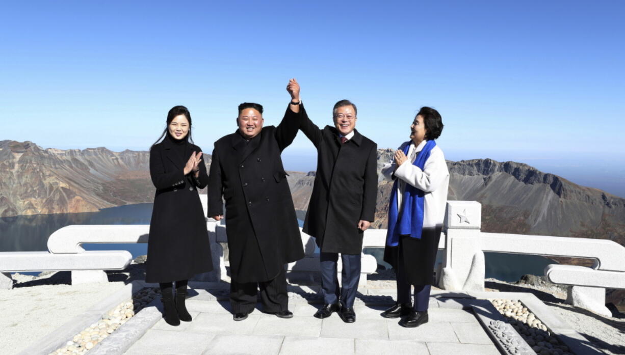 South Korean President Moon Jae-in, second from right, and his wife Kim Jung-sook, right, stand with North Korean leader Kim Jong Un, second from left, and his wife Ri Sol Ju on the Mount Paektu in North Korea on Thursday.