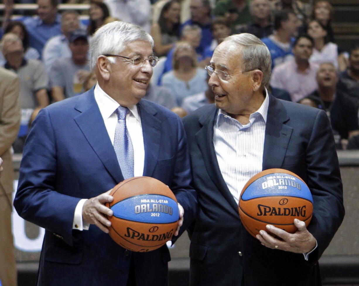 FILE - In this May 4, 2010, file photo, NBA commissioner David Stern, left, chats with Orlando Magic owner Rich DeVos during the first half of Game 1 in a second-round of the NBA basketball playoff series between the Magic and the Atlanta Hawks in Orlando, Fla. DeVos, the billionaire co-founder of direct-selling giant Amway and father-in-law of Education Secretary Betsy DeVos, died Thursday, Sept. 6, 2018. He was 92.