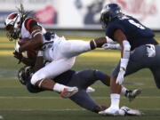 Oregon State’s Christian Wallace (29) catches a first down pass in front of Nevada’s Jomon Dotson (23) and Nephi Sewell (6) during the second half of an NCAA college football game, Saturday, Sept. 15, 2018, in Reno, Nev.