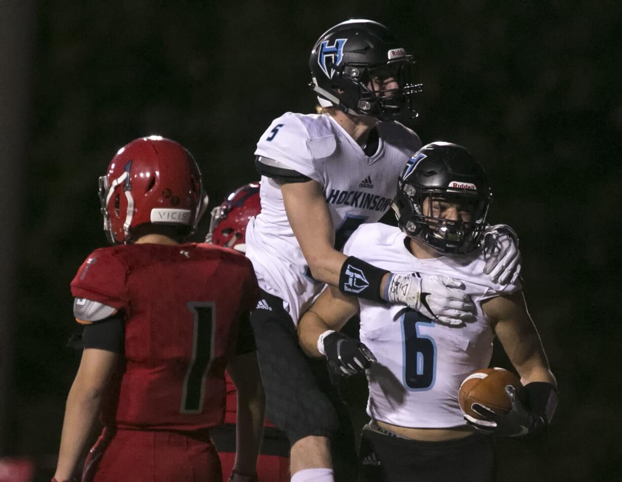 Hopkinson's Wyatt Jones (center) celebrates teammate's Nick Charles (right) touchdown with Archbishop Murphy's Matthew Mavis (left) walking away in the second quarter Thursday night at Archbishop Murphy High School in Everett on September 6, 2018.