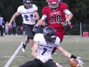 Hockinson's Nick Charles (bottom) works to gather a blocked punts with Archbishop Murphy's Evan Thode (28) trailing Thursday night at Archbishop Murphy High School in Everett on September 6, 2018.