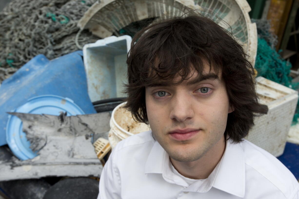 In this May 11, 2017, file photo, Dutch innovator Boyan Slat poses for a portrait next to a pile of plastic garbage prior to a press conference in Utrecht, Netherlands. Engineers will deploy a trash collection device to corral plastic litter floating between California and Hawaii in an attempt to clean up the world's largest garbage patch in the heart of the Pacific Ocean. The 2,000-foot (600-meter) long floating boom will be towed Saturday, Sept. 8, 2018, from San Francisco to the Great Pacific Garbage Patch, an island of trash twice the size of Texas. The system was created by The Ocean Cleanup, an organization founded by Slat.