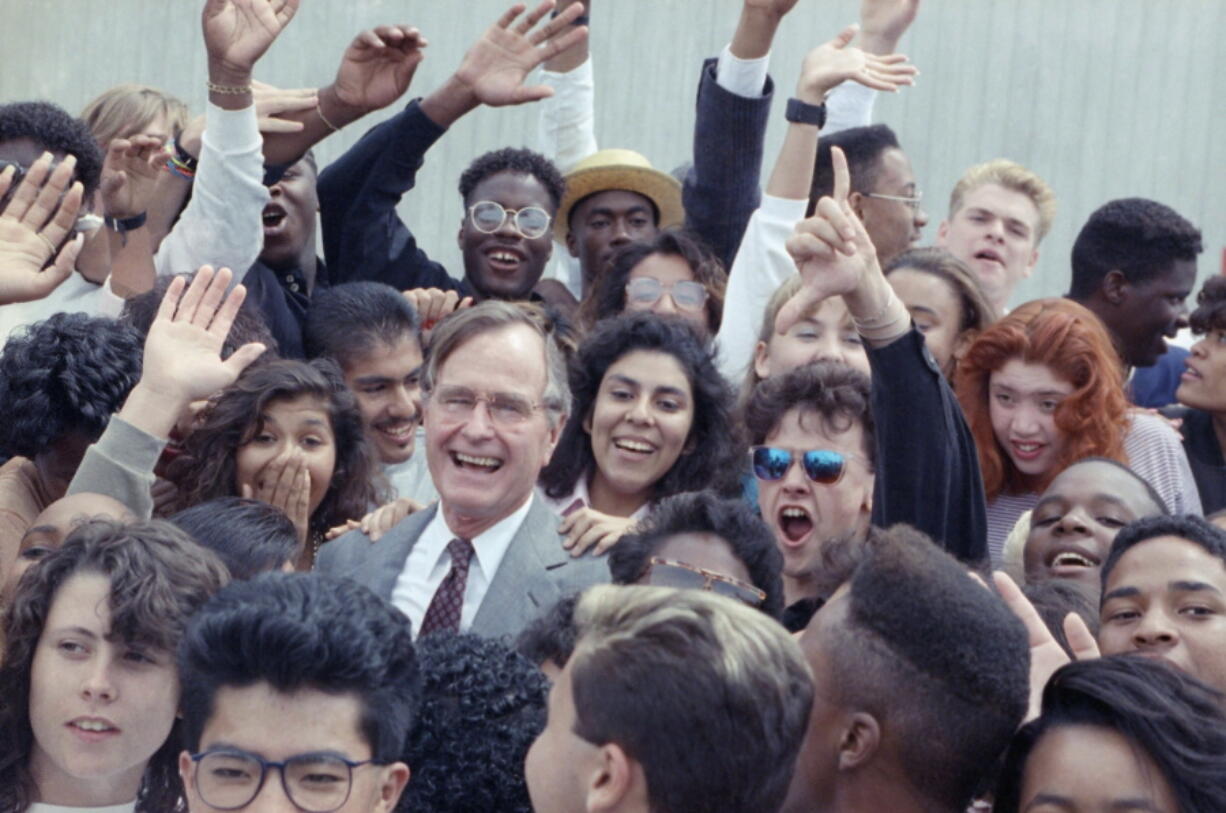 President George H.W. Bush is surrounded by cheering students from the Independent Living Program in Los Angeles on May 21, 1990, as he prepares to leave Los Angeles International Airport. Bush’s volunteerism concept is still going strong three decades later.