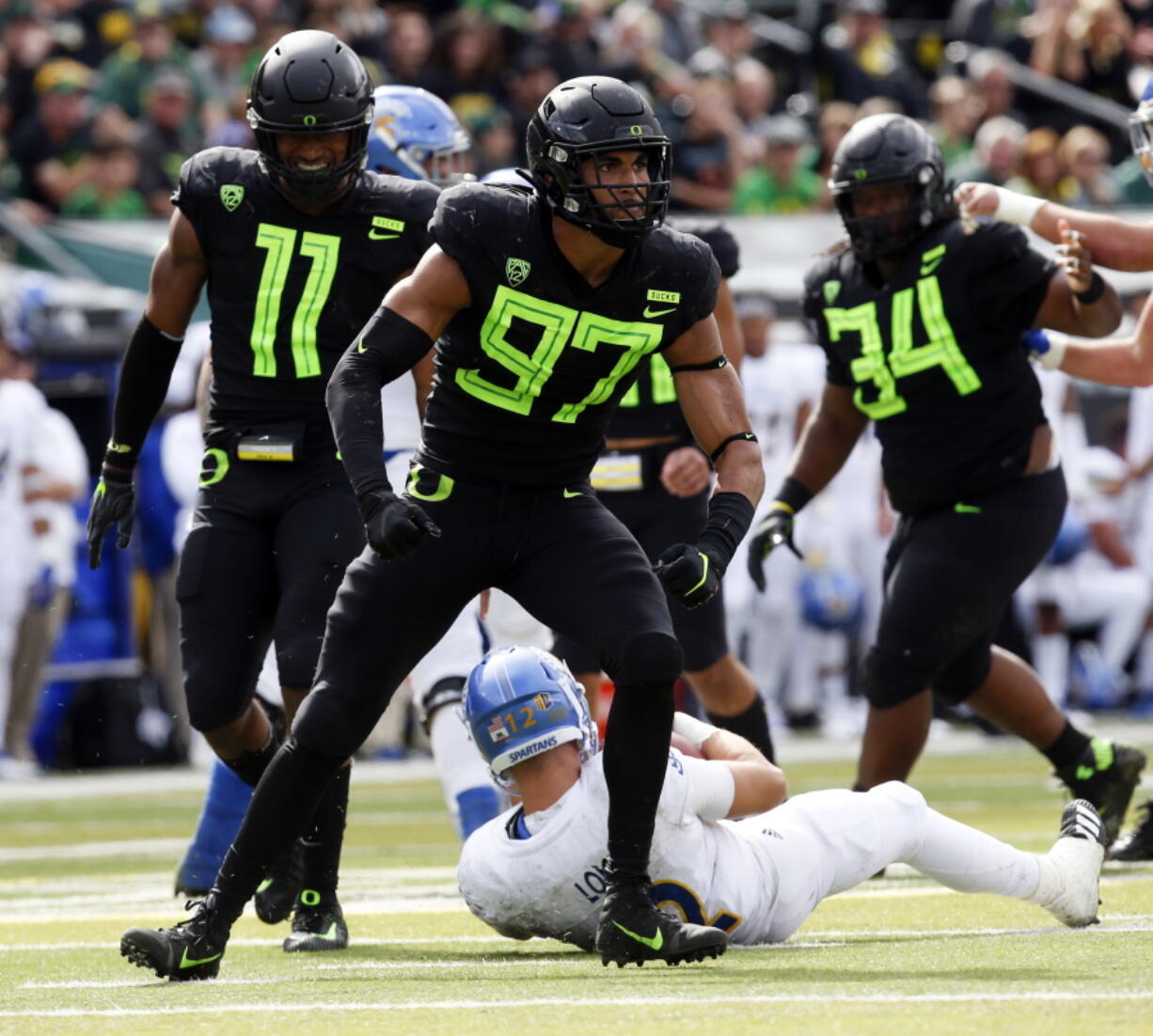 Oregon linebacker Jalen Jelks (97) flexes after sacking San Jose State quarterback Josh Love during the second quarter of an NCAA college football game at Autzen Stadium, Saturday, Sept. 15, 2018, in Eugene, Ore.