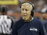 Seattle Seahawks head coach Pete Carroll looks at the scoreboard during the first half of an NFL football game against the Chicago Bears Monday, Sept. 17, 2018, in Chicago.