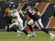 Chicago Bears linebacker Khalil Mack (52) chases Seattle Seahawks quarterback Russell Wilson (3) during the second half of an NFL football game Monday, Sept. 17, 2018, in Chicago. (AP Photo/Nam Y.