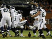 Seattle Seahawks quarterback Russell Wilson (3) loses a ball during the first half of an NFL football game against the Chicago Bears Monday, Sept. 17, 2018, in Chicago.