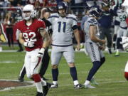 Seattle Seahawks kicker Sebastian Janikowski (11) celebrate his game-winning field goal with punter Michael Dickson (4) as Arizona Cardinals linebacker Dennis Gardeck (92) looks away during the second half of an NFL football game, Sunday, Sept. 30, 2018, in Glendale, Ariz. The Seahawks won 20-17. (AP Photo/Ross D.