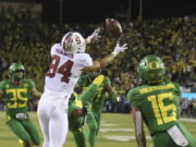 Stanford’s Colby Parkinson, center, pulls down a touchdown pass in overtime against Oregon during NCAA college football game Saturday Sept. 22, 2018, in Eugene, Ore.