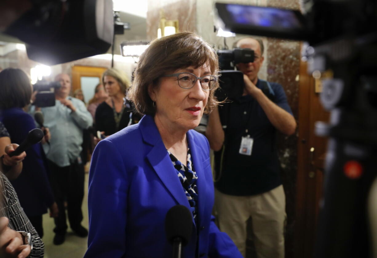 Sen. Susan Collins, R-Maine, walks past members of the media as she arrives at her office on Capitol Hill in Washington on Monday.