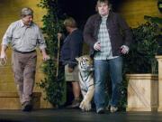 Living Hope Church pastor John Bishop got up close and personal with a tiger named Sundar at a service in 2007,  during the last of the ARK series, "Risk of Moving." From left are Dan Stockdale of Harriman, Tenn., left, and Rick Kelly of San Bernadino, Calif., owner of Amazing Animal Productions.