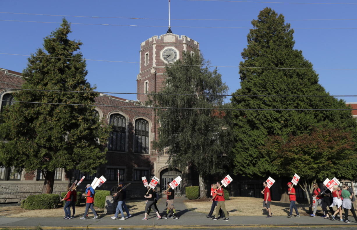 Striking Tacoma Public Schools teachers walk a picket line Thursday in front of Lincoln High School in Tacoma. (Ted S.