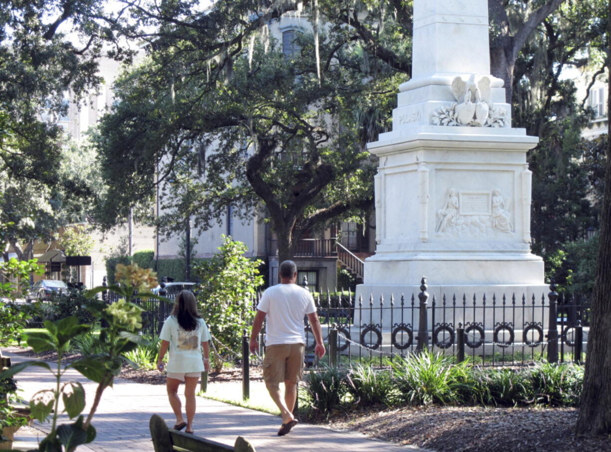 People stroll through Monterey Square in the historic landmark district of Savannah, Ga., on Aug. 31. Savannah’s historic district was named a National Historic Landmark in 1966 and it remains one of the largest in the U.S. The National Park Service recently announced it has downgraded the Savannah landmark district’s condition from “satisfactory” to “threatened.” The agency said decades of new development and modernization have eroded the unique town plan devised for Savannah by British Gen. James Edward Oglethorpe, who founded Georgia in 1733.