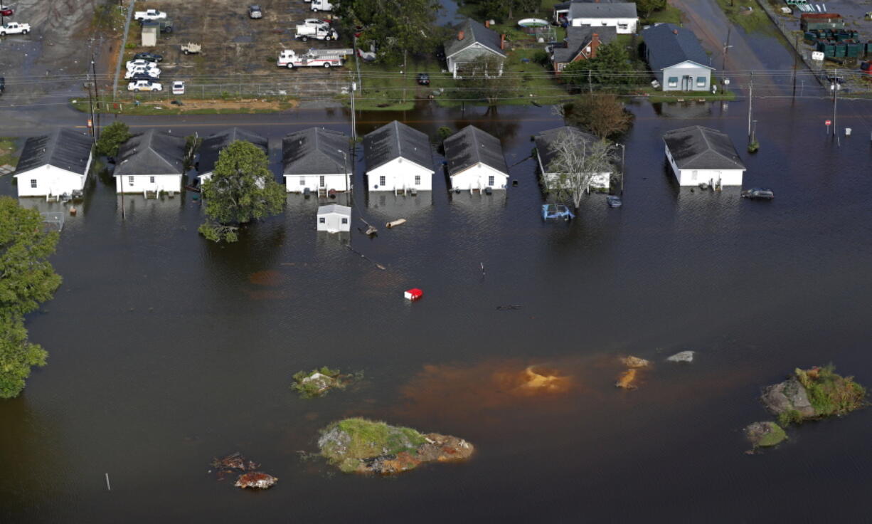 Floodwaters from Hurricane Florence surrounds homes in Dillon, S.C. Scientists say climate change likely boosted rainfall totals for both Florence and 2017’s Harvey.