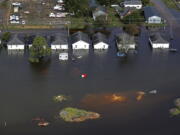 Floodwaters from Hurricane Florence surrounds homes in Dillon, S.C. Scientists say climate change likely boosted rainfall totals for both Florence and 2017’s Harvey.