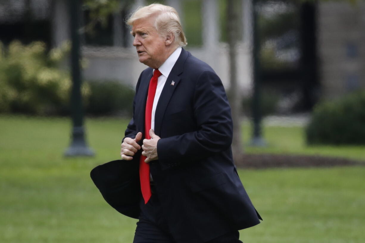 President Donald Trump walks across the South Lawn on return from New York City on Thursday at the White House in Washington.