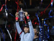 Naomi Osaka, of Japan, holds the trophy after defeating Serena Williams in the women’s final of the U.S. Open tennis tournament, Saturday, Sept. 8, 2018, in New York.