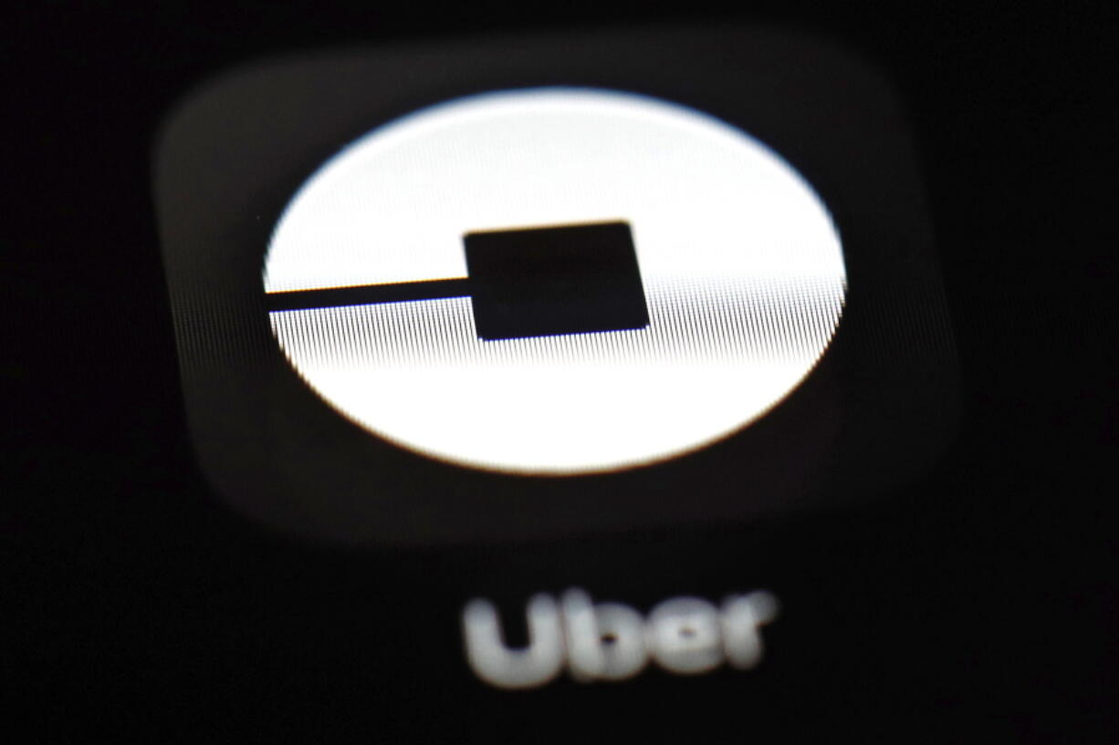 FILE - This March 20, 2018, file photo shows the Uber app on an iPad in Baltimore. Uber has agreed to pay $148 million and take steps to tighten data security, after the ride-hailing company failed for a year to notify drivers that hackers had stolen their personal information.